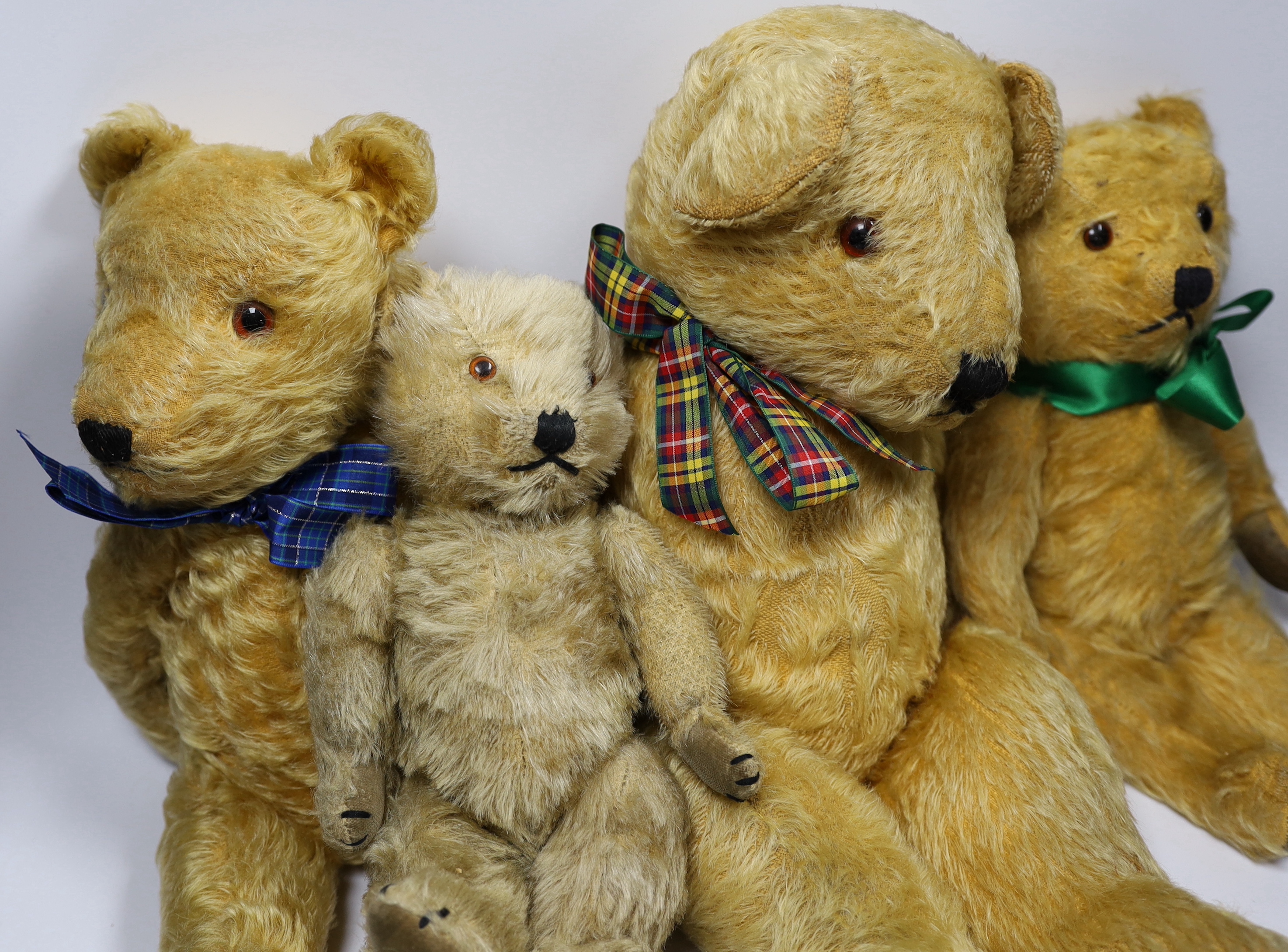 Three Chilterns bears, 1950's, worn, and a large English bear, 42cm (4)